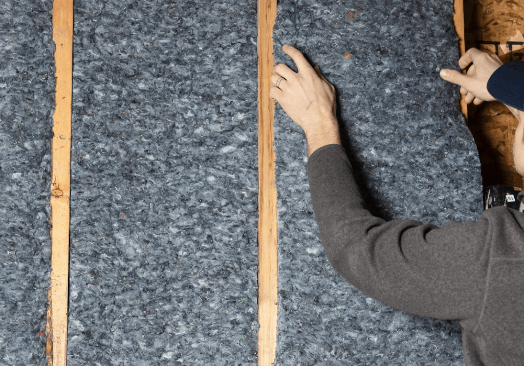 An image of denim insulation being installed.