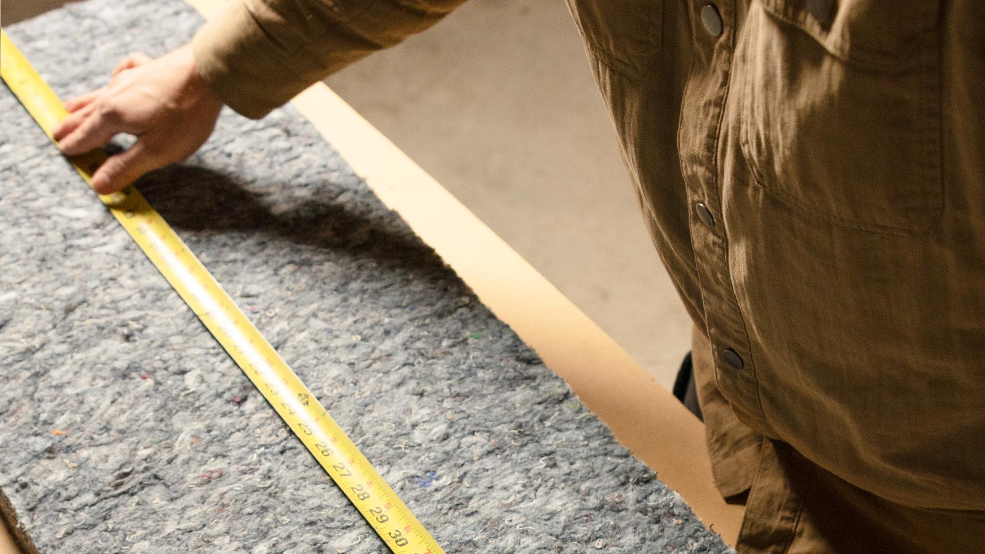 Man Measures Insulation for a DIY Installation