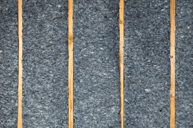 Denim insulation installed between wooden wall studs